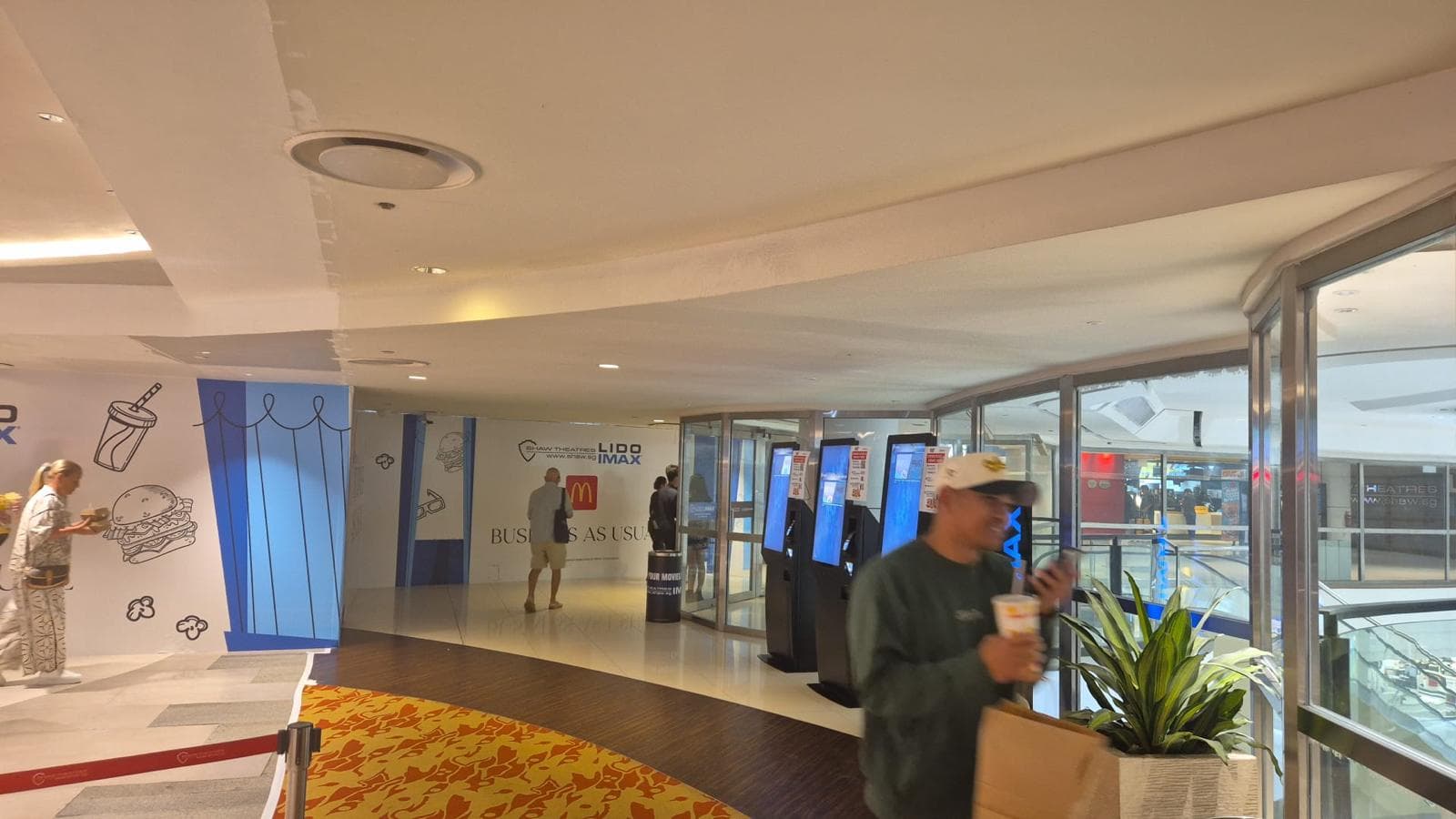 Shaw Lido foyer with glazed frontage, self-service kiosks and temporary hoarding