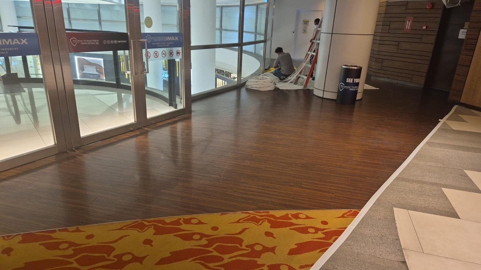 Dark flooring along the glazed Shaw Lido entrance